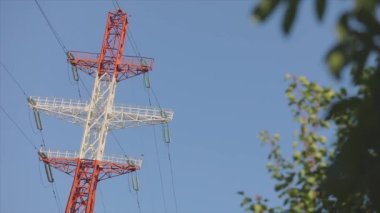 Power line against the blue sky. Modern high voltage tower. Electrical Transmission Tower against the blue sky. High Voltage Transmission Tower.