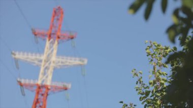 Power line against the blue sky. Modern high voltage tower. Electrical Transmission Tower against the blue sky. High Voltage Transmission Tower.