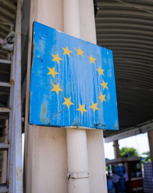 Romanya 'nın Avrupa Birliği sembolüyle olan sınırında yıpranmış ve paslanmış bir tabelayla sığ alan derinliği (seçici odak) resmi.