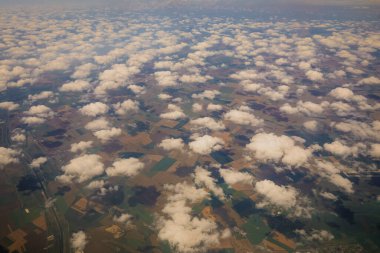 Cloud formations above the southern part of Romania as seen from an aeroplane on a sunny summer day.