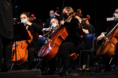 Bucharest, Romania - January 15, 2022: Members of a classical music orchestra perform during an event.