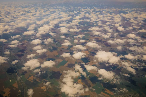 Cloud formations above the southern part of Romania as seen from an aeroplane on a sunny summer day.
