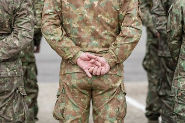 Bucharest, Romania - April 28, 2022: Romanian land forces soldiers take part at a public ceremony. clipart