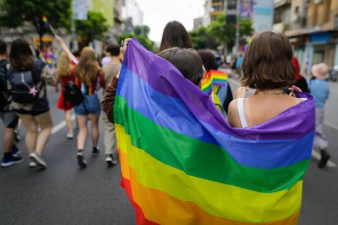 Shallow depth of field (selective focus) with people attending the Pride March on the streets of Bucharest, Romania.