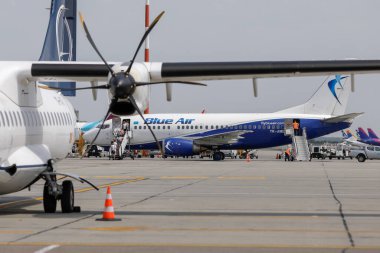 Otopeni, Romania - August 9, 2022: Passengers board a Blue Air aeroplane on Henri Coanda International Airport.