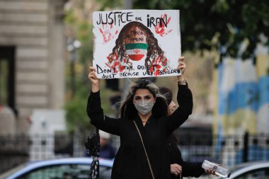 Bucharest, Romania - October 1, 2022: Details of people protesting against the death of the Iranian Masha Amini and for women's fundamental rights in Iran, outside the Iranian embassy in Bucharest. clipart