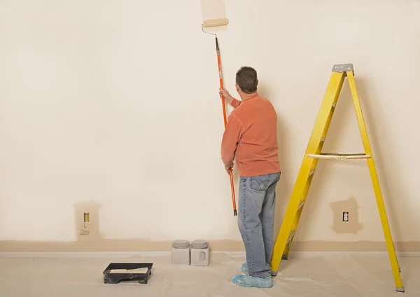 Man Painting A Wall With Copy Space To The Left — Stock Photo, Image