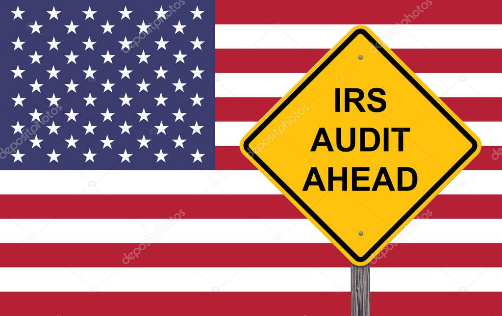 IRS Audit Ahead Caution Sign - Flag Background