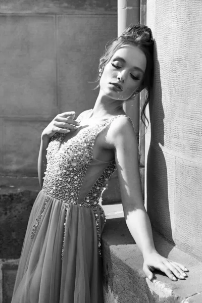 Portrait of beauiful European girl bridesmaid wearing classic dress. Black and white photograph. — Foto de Stock