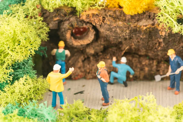 Miniature workers clearing a pathway after storm — Stock Photo, Image