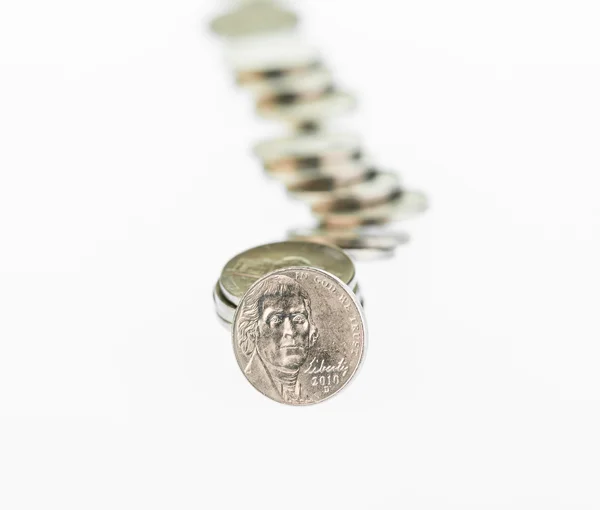 Fallen stack of US coins over white background — Stock Photo, Image