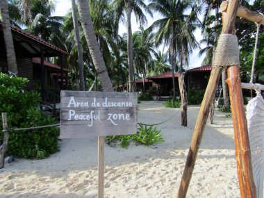 Peaceful Zone sign on sandy Xcalacoco Beach, Playa del Carmen, Yucatan Peninsula`s Riviera Maya, Mexico. clipart