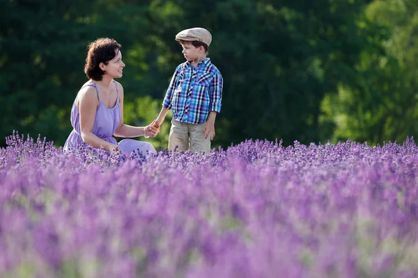 Woman and her little son in lavender field — Stock Photo, Image