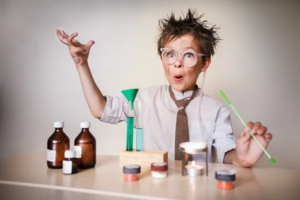 Crazy scientist. Young boy performing experiments — Stock Photo, Image