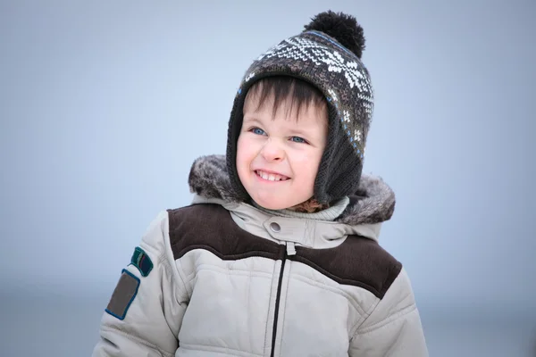 冬のビーチで楽しく魅力的な小さな男の子 — ストック写真