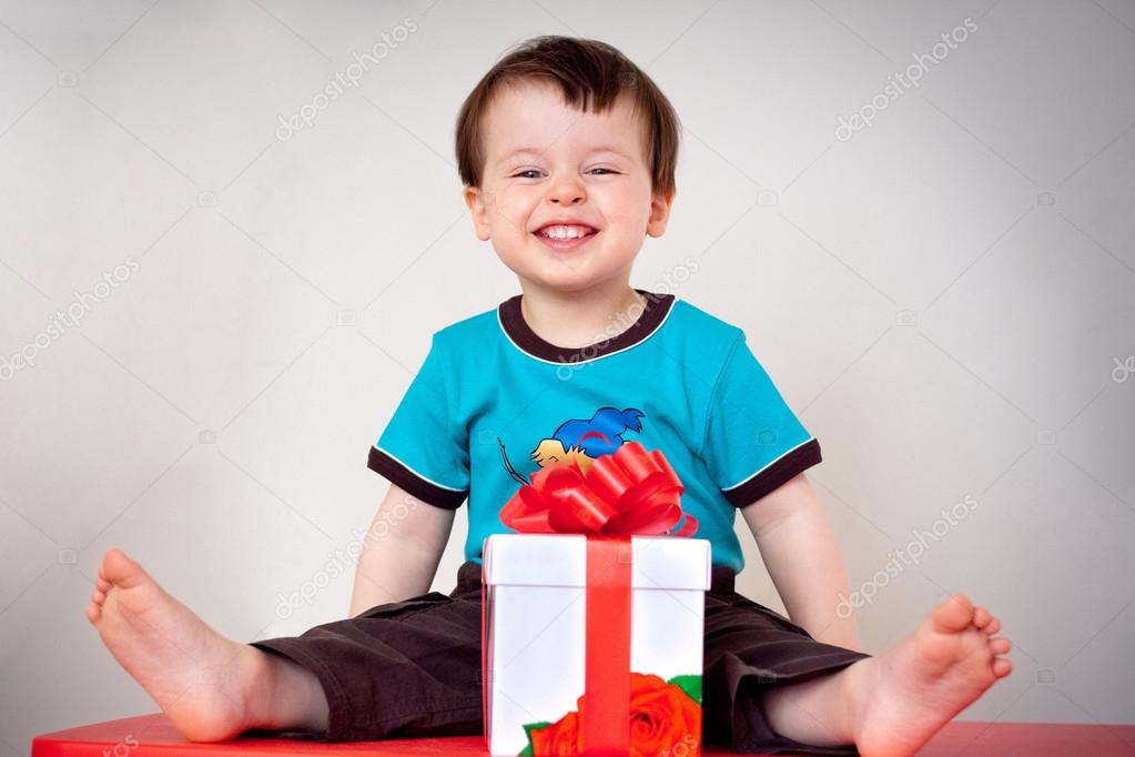 Happy toddler boy with a gift box