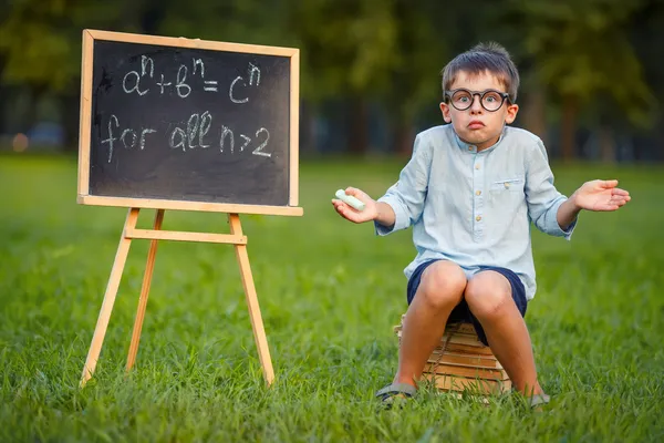 Cute little confused student — Stock Photo, Image