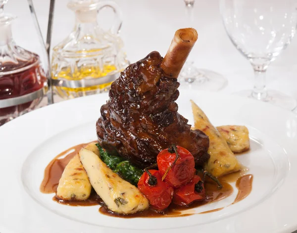 Lamb knuckle with roasted potato sticks — Stock Photo, Image