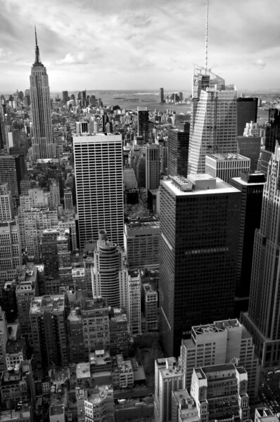 Vertical black and white photo of New Yorks Manhattan, Empire State Building in background