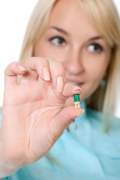 Nurse with a green capsule in a hand — Stock Photo, Image