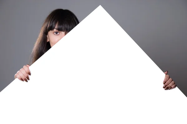 Girl hidden behind a white sheet of paper — Stock Photo, Image