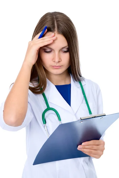 Attractive lady doctor attentively looking at the medical record — Stock Photo, Image