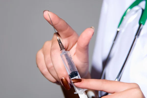 Hand with a syringe — Stock Photo, Image