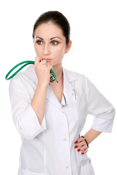Nadenkend verpleegster met een stethoscoop kin — Stockfoto