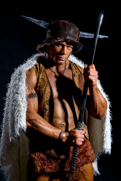 Male warrior with a sword in a fur cape — Stock Photo, Image