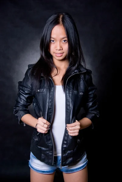 Asian girl in studio on dark background — Stock Photo, Image