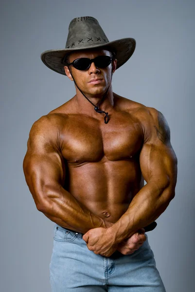 Handsome muscular man with a hat — Stock Photo, Image