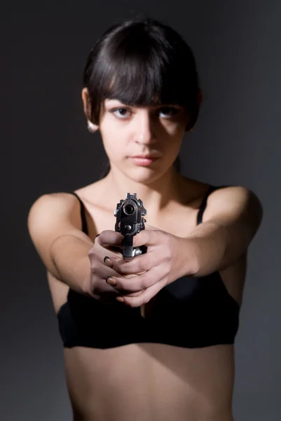 Beautiful sexual girl brunette with gun — Stock Photo, Image