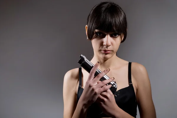 Shot of a beautiful girl holding gun — Stock Photo, Image