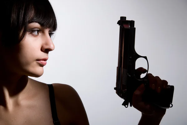 Close-up portrait of sexy woman with gun — Stock Photo, Image