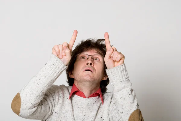 Man with disheveled hair pointing two fingers at something inter — Stock Photo, Image