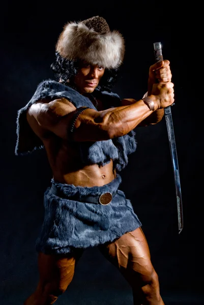 Male warrior with a sword in the form of a barbarian — Stock Photo, Image