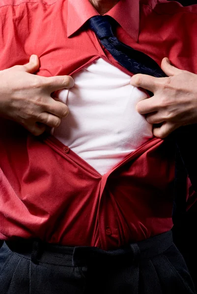 Cropped view of frustrated man tearing off his shirt on black b — Stock Photo, Image