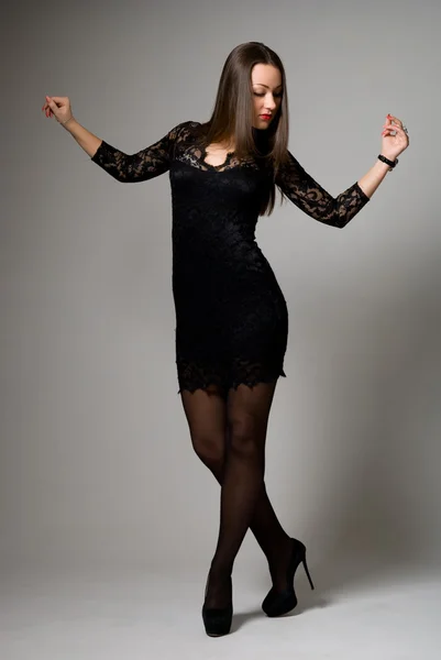 Beautiful girl in black dress dancing — Stock Photo, Image