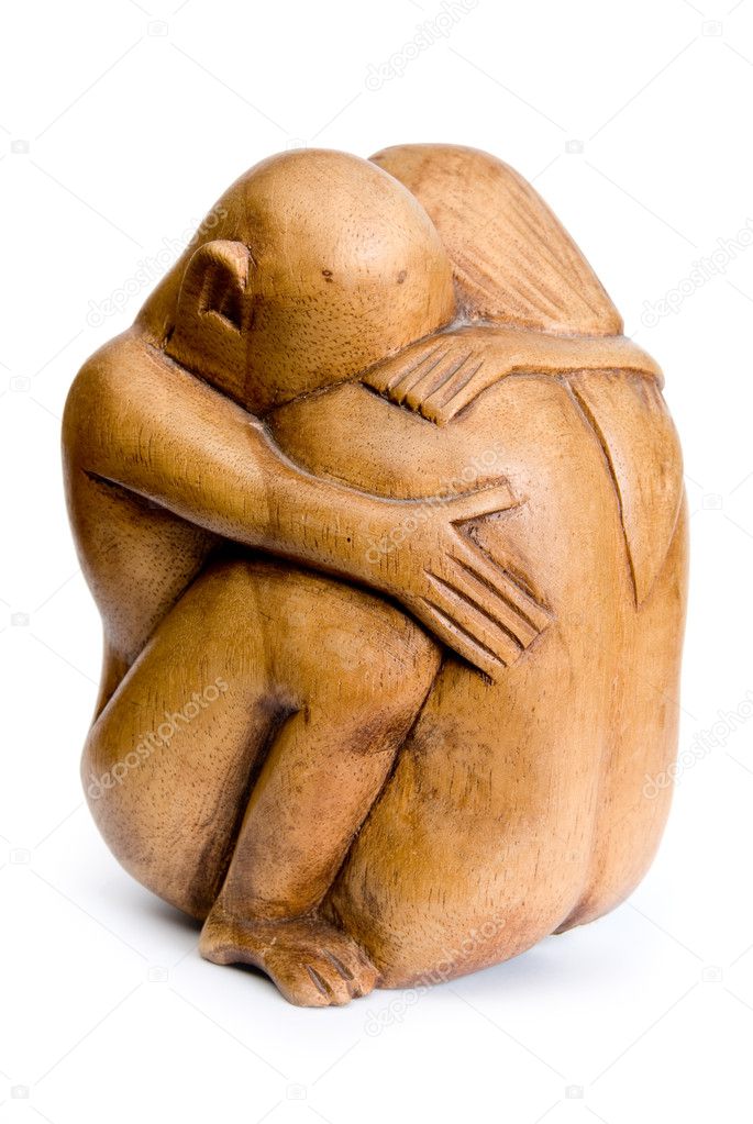 Wooden figurines to hug couple. A side view.