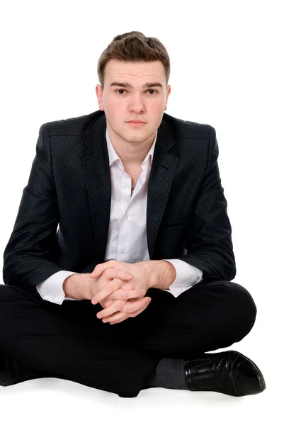 Young man sits on floor — Stock Photo, Image