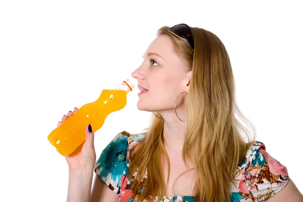 Portrait of a beautiful girl with a bottle of orange juice — Stock Photo, Image