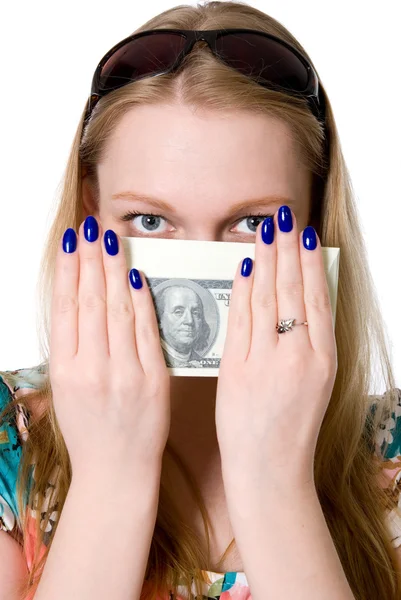 A young girl covers her face with a pack of dollars. — Stock Photo, Image