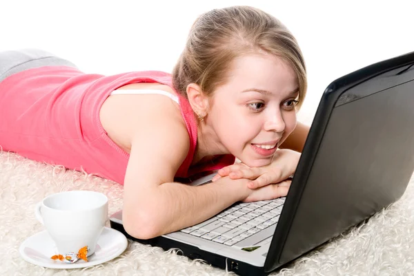 Fröhliches Mädchen auf dem Boden liegend vor ihrem Laptop — Stockfoto