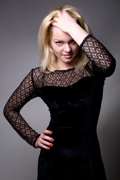 Portrait of a beautiful blonde in a black dress — Stock Photo, Image