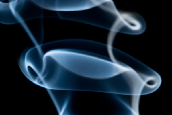 Blue smoke curls on a black background — Stock Photo, Image