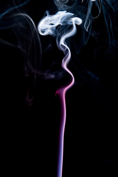 Multi-colored smoke on a black background.