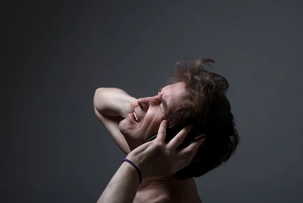 Un hombre escucha música en los auriculares . —  Fotos de Stock