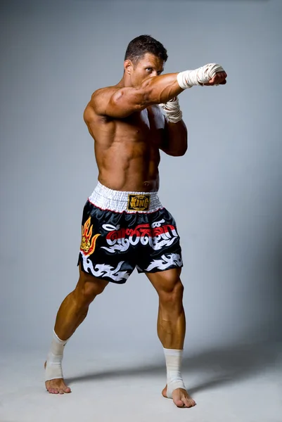 Experienced adult fighter punches during training. Kickboxing — Stock Photo, Image