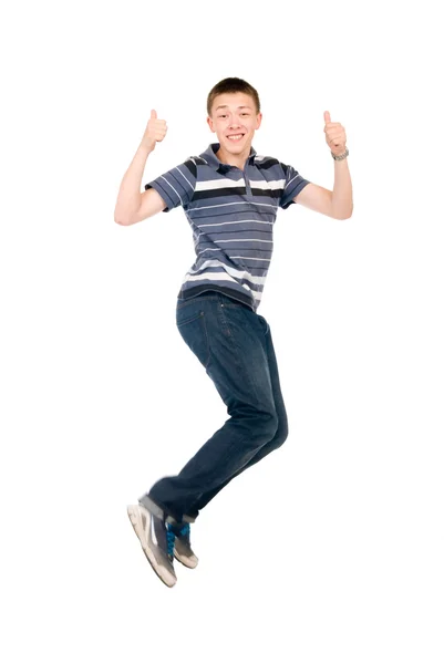 Young man jumping with raised thumbs up. — Stock Photo, Image