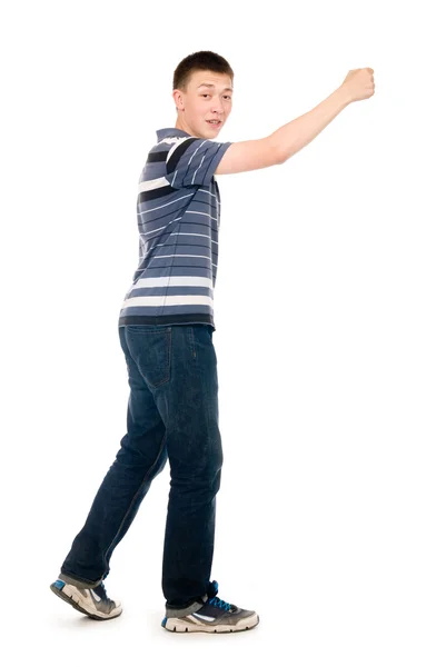 Portrait of a young man walking with his hand raised — Stock Photo, Image